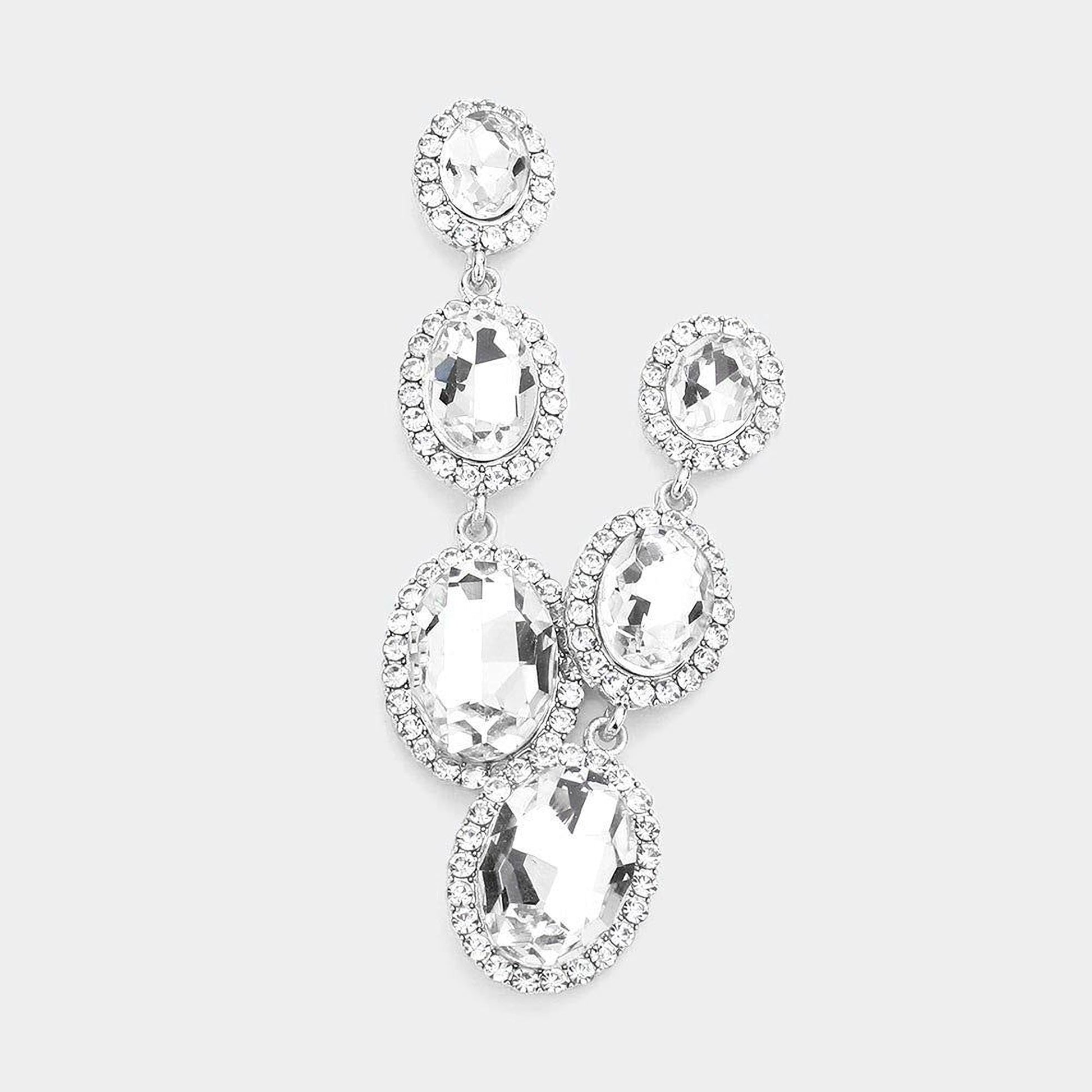 A pair of elegant earrings with large, clear gemstones set in a halo-like design.